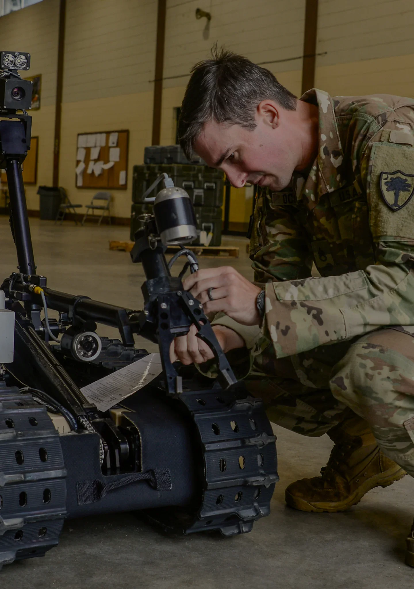 A combat engineer preparing a robotic vehicle for a route clearance training